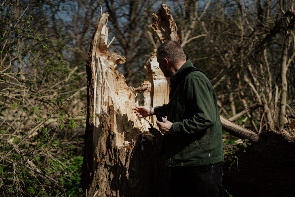 Photographer Paul Fuller in front of a tree stump in the Hackney Marshes