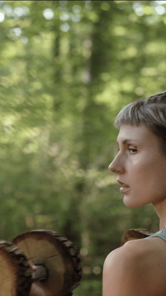 film clip video of a girl excercising in the woods