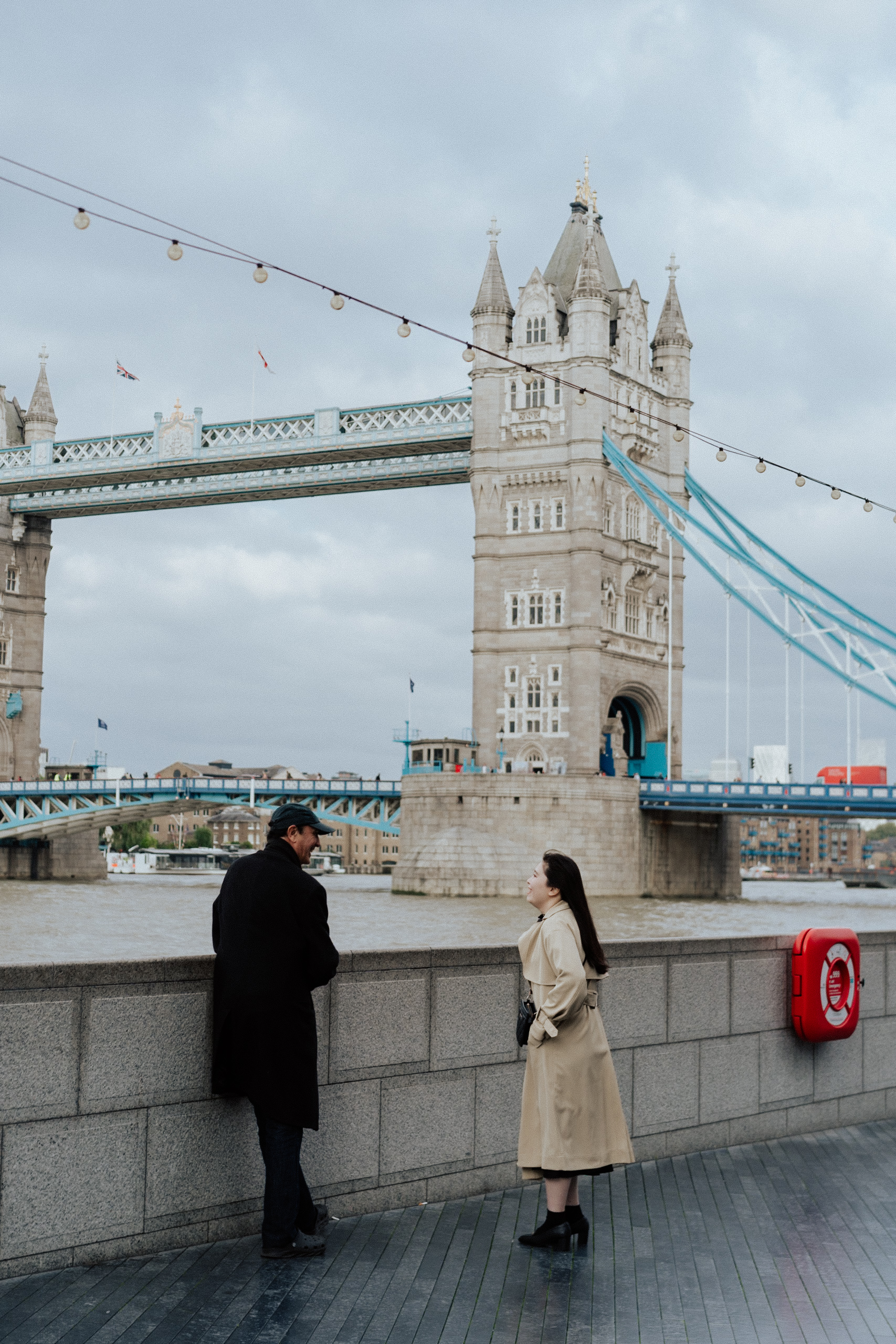 a beautiful london moment of two people talking at Tower Bridge in London