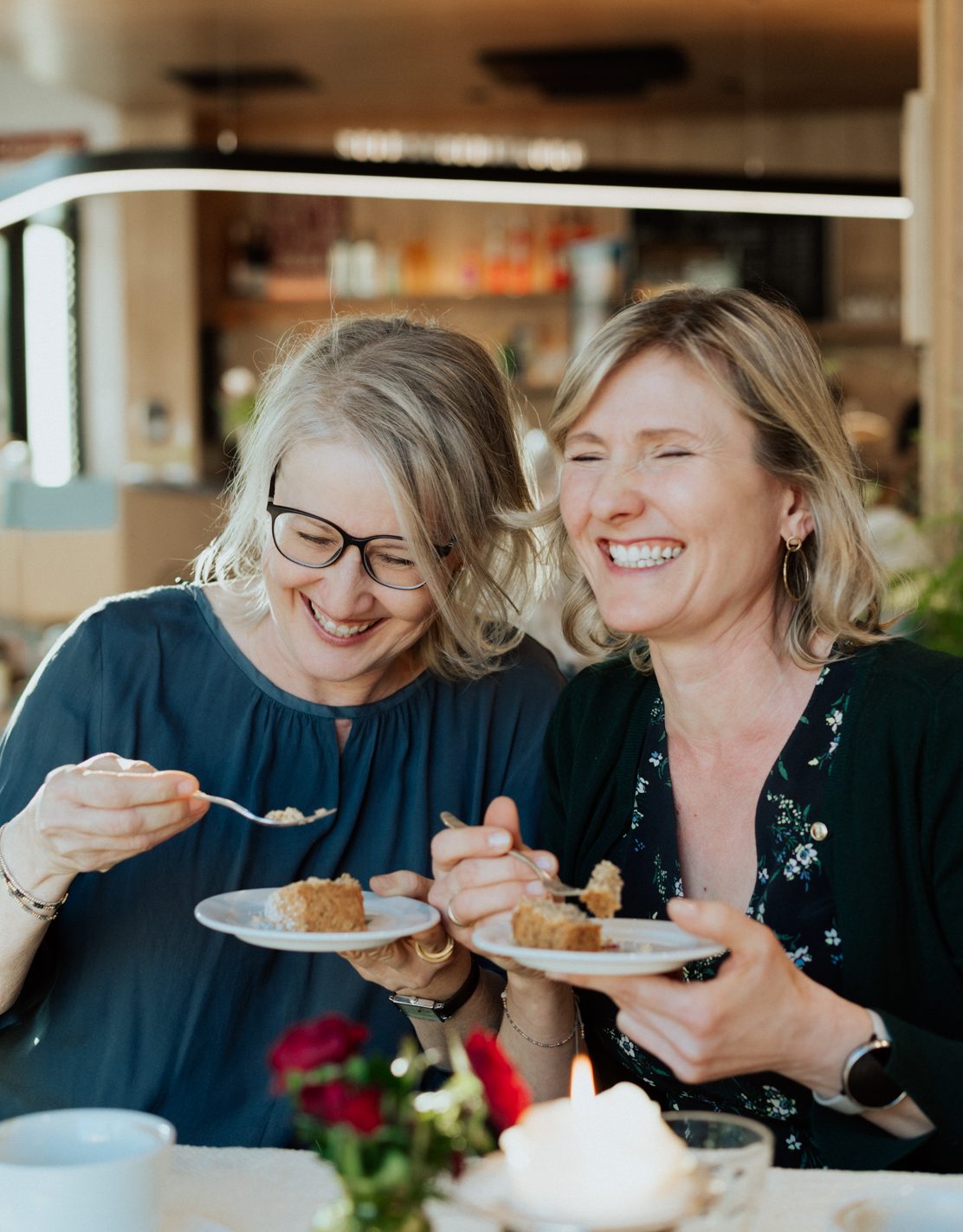 Photo of two sisters eating cake