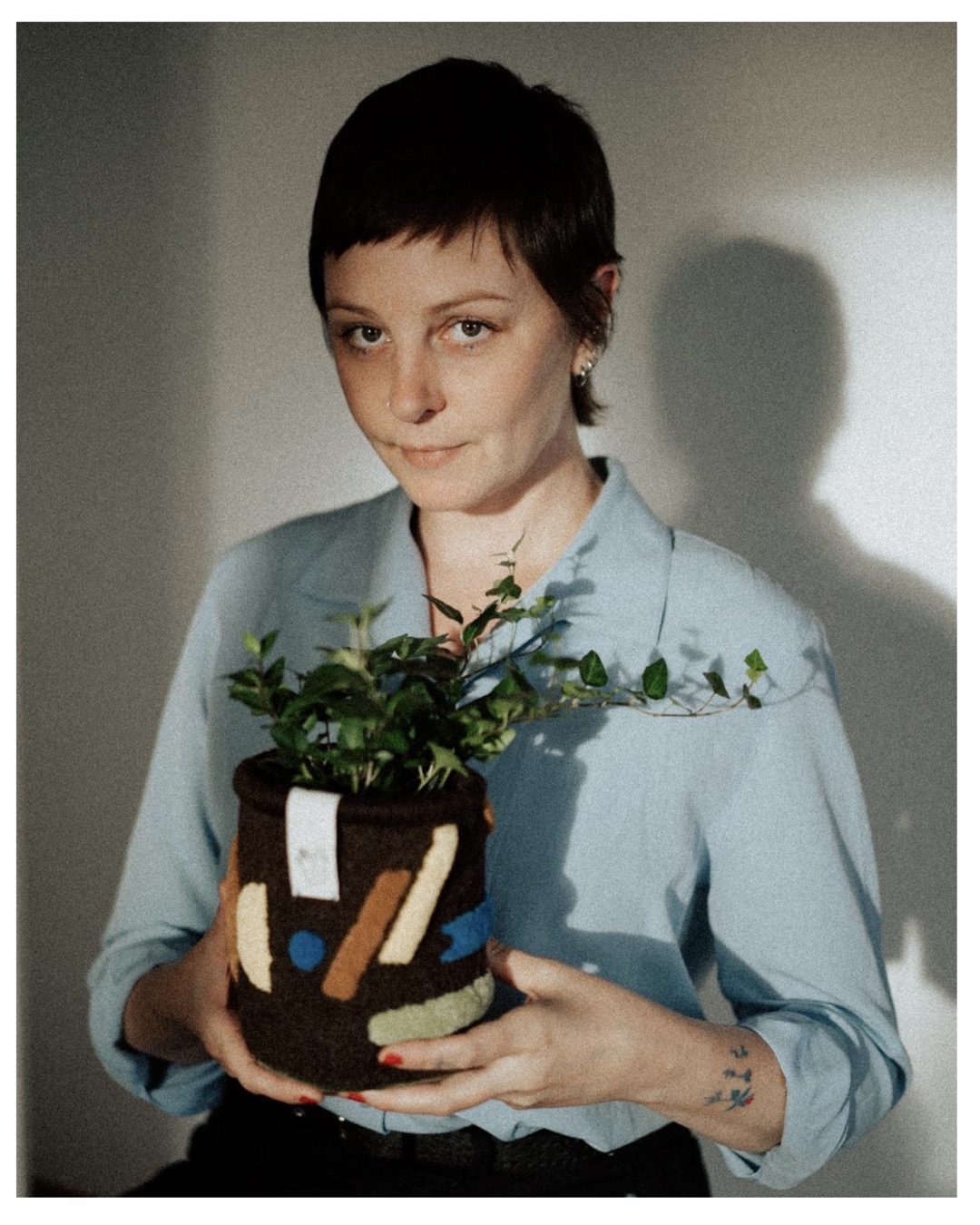 Art and Photography: Photograph of an artist holding her crafted plant pot