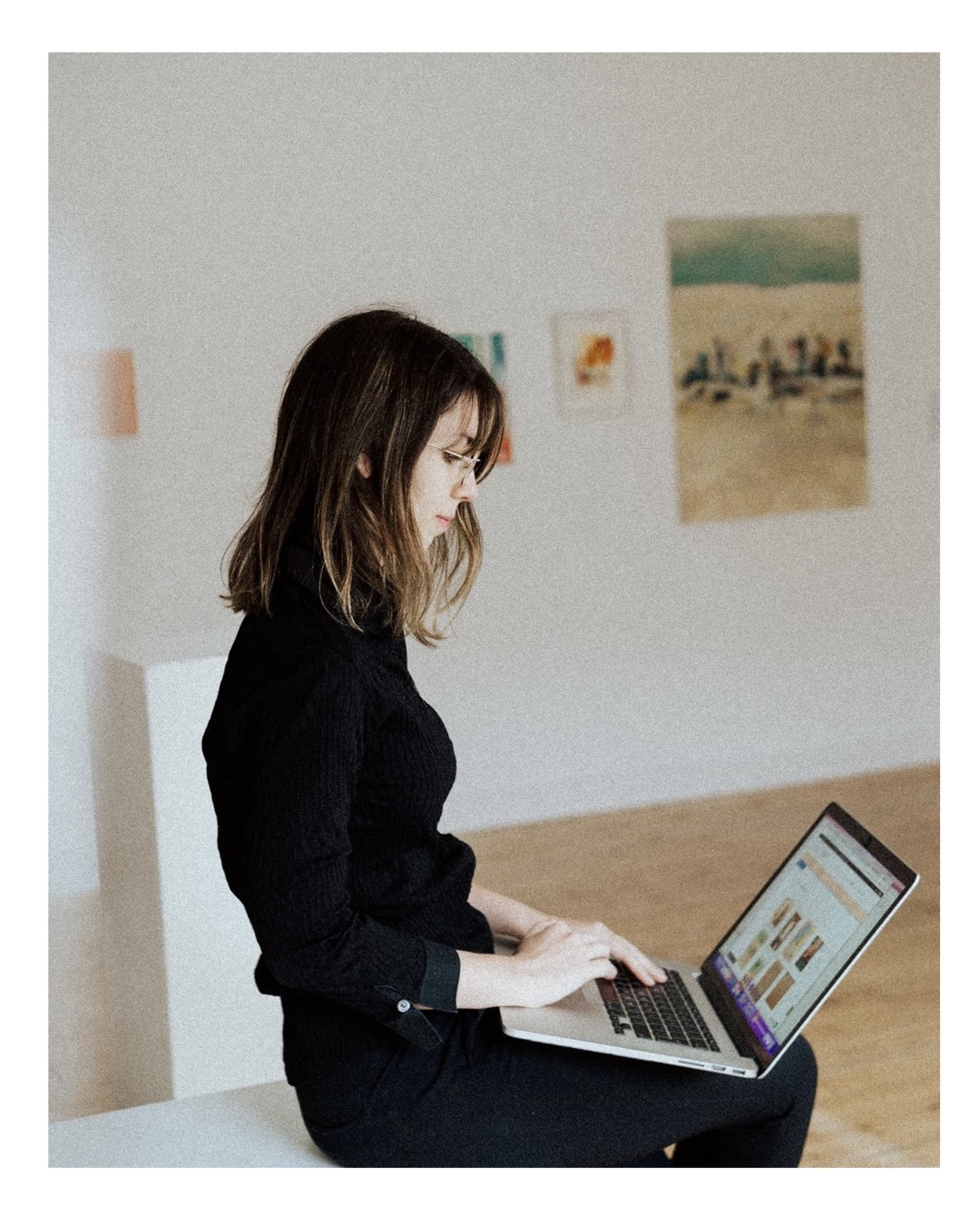 gallerist working in her gallery