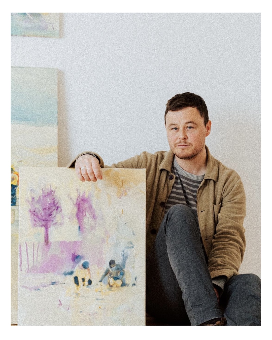 artist Freddie Darke with paintings