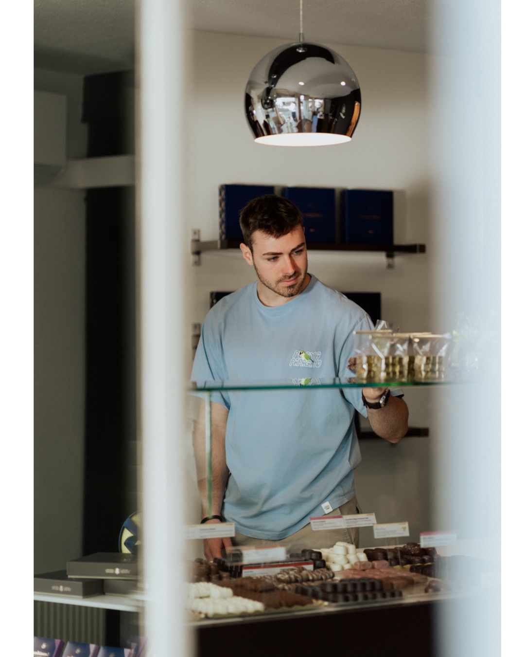Man looking at chocolates in a Leonidas Store in Reutlingen