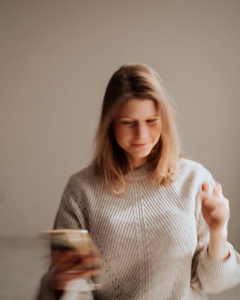 woman celebrating over phone call when the right client says yes