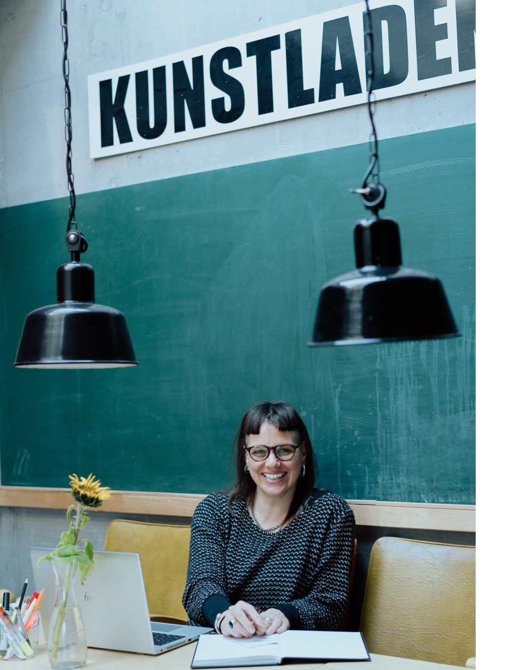 Environmental Portrait of Sarah Petrasch under lamps in her office in the Franz K Reutlingen captured by Lifestyle Business Photographer Nadine Wilmanns / Business Fotografin Nadine Wilmanns