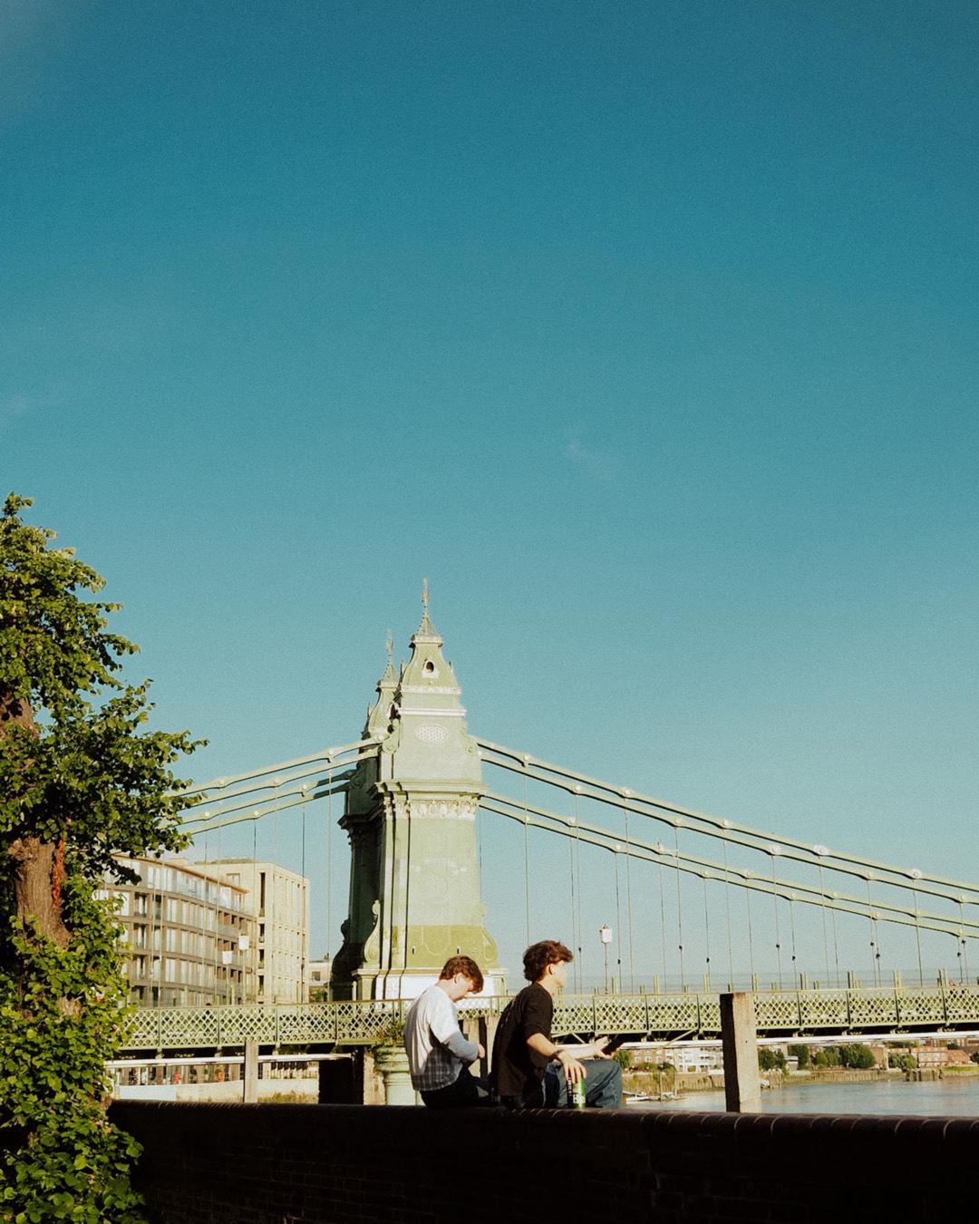 people sitting by the water at Hammersmith Riverside London
