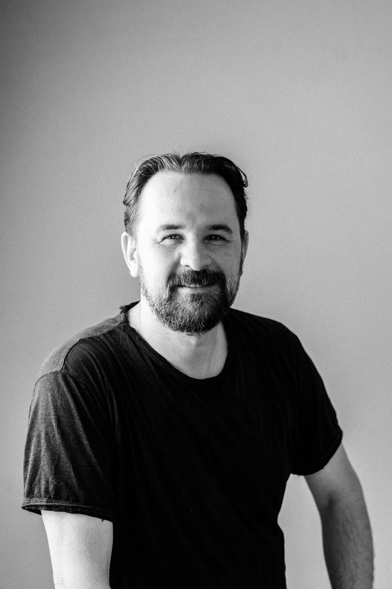 Matthias Schulz portrait photographer and founder of Rolling Rotors smiling in studio and discussing business defining moments
